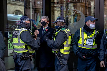 Police arrest an activist outside the energy company SSE while climate activists take part in a â��Greenwash' march through central Glasgow. Police closed roads and encircled the activists, causing g...