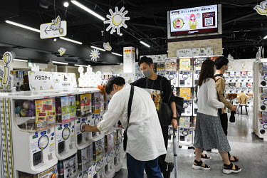Customers buy capsules at 'gachapon Department Store Ikebukuro Sohonten', a specialist capsule toy shop in Tokyo.