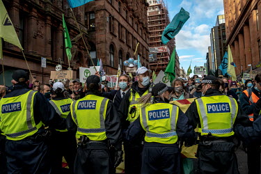 Climate activists take part in a â��Greenwash' march through central Glasgow. Police closed roads and encircled the activists, causing groups to break away and start a cat and mouse game between poli...