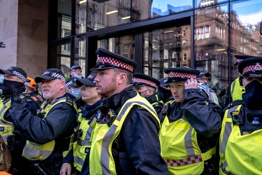 Police watch as climate activists take part in a â��Greenwash' march through central Glasgow. Police closed roads and encircled the activists, causing groups to break away and start a cat and mouse g...