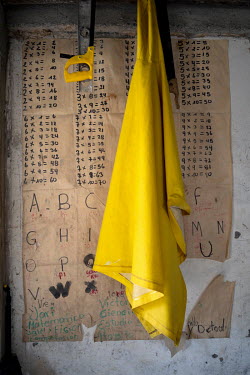 A poster of the alphabet and multiplication tables in the living room of the Ayovi family at Playa de Oro. Parents have to create different learning resources for their children to face the struggles...