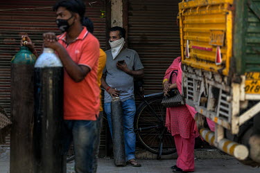 Relatives of people with Covid 19 who are in need of oxygen wait at a shop in south Delhi to exchange empty cylinders for full ones.