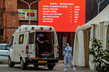 An ambulance parked in front of a digital display showing the lack of availability of beds at LNJP hospital during the coronavirus pandemic in Delhi.