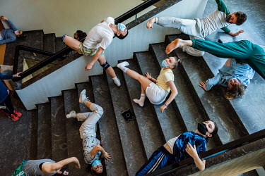 Dancers from the Ballet Junior Geneve, warming up on the stairways before an experimental training performance at the Museum d'histoire naturelle. Despite having no public performances, the dancers ha...