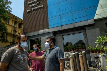 Relatives of people with Covid 19 wait outside a hospital in Delhi as the hospital sends SOS calls to government and on twitter for oxygen.