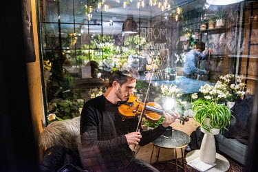Brazilian violinist Rosnei Tuon of the Orchestre de la Suisse Romande preparing to give a series of short solo performances in flower shop Fleuriot in central Geneva. He will perform for a single memb...