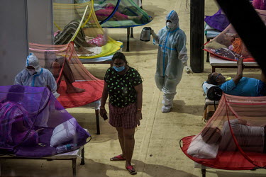 Health workers in personal protective equipment care for patients in a temporary medical facility set up during the Covid 19 pandemic in Delhi at the Commonwealth Games site.