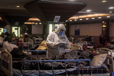 A doctor in personal protective equipment attends to patients in a temporary medical facility set up during the Covid 19 pandemic in Delhi, opposite the Lok Nayak Jai Prakash Narayan hospital.