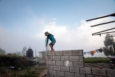 A girl plays in the courtyard of her house in the Karanki community of Chirihausi.