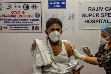 A man receives a Covid 19 vaccine at Rajiv Gandhi hospital in Delhi.