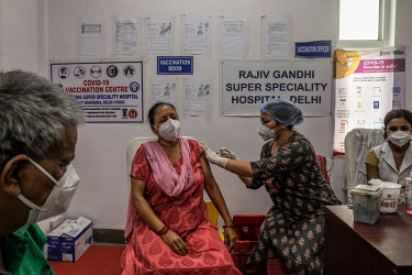 A woman receives a Covid 19 vaccine at Rajiv Gandhi hospital in Delhi.