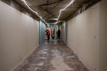 Cleaners work in a corridor in the Palais des Nations, the United Nations Office at Geneva, which is being overhauled as part of an $800 million renovaton and construction project.