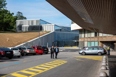 Diplomats walk near the new 'H' building of the Palais des Nations, the United Nations Office at Geneva, part of an $800 million project.