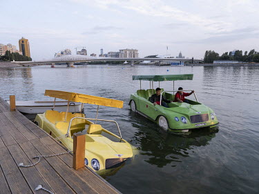 Two young men use a pedalo on the Ishim river.