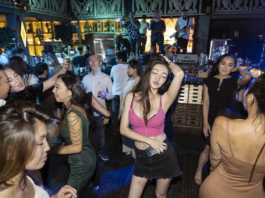 Young men and women enjoy a night out at the Nightclub Zoloto.