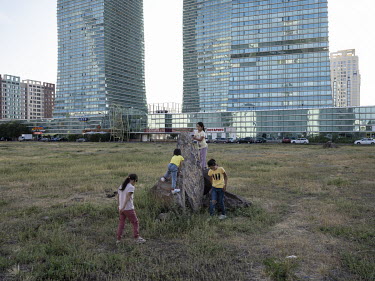 Children play on a vacant lot near the Northern Lights high rises along Nurzhol Boulevard in central Nur-Sultan.