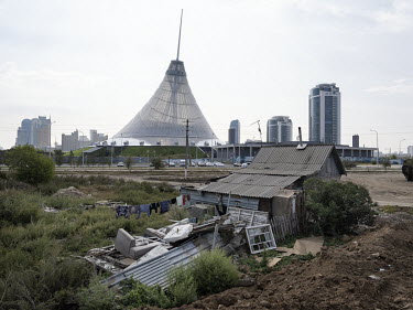 An old house with corrugated iron roof stands in what used to be the outskirts of Nur-Sultan. Original residential neighbourhoods are being systematically demolished to make way for the new developmen...