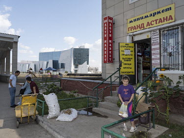 People in front of a shop in Grand Astana. In the background - The National Museum of the Republic of Kazakhstan.