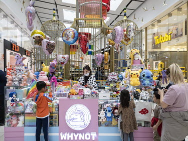 Children look at toys at a stall in the Mega Silk Way shopping mall.
