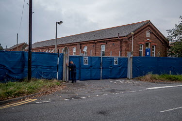 An Asylum seeker enters Napier Barrack. The delapidated former Army barracks are being used to house refugees who have been picked up on the English Channel.