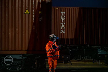 A local worker oversees a freight train being loaded with 650,000 bottles of wine at Tilbury Docks, east of London. Due to supply problems and driver shortages caused by Brexit and the Pandemic, wine...