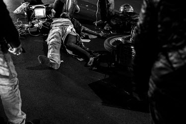 A Congolese migrant delivery driver who has been seriously injured in a hit and run accident in Sandton lies on the ground next to his bike, surrounded by emergency staff. Video footage showed how a c...