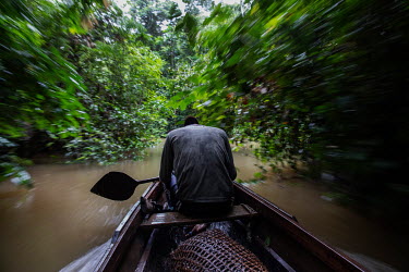 Jasson Oliveira do Nascimento, resident of the Arapixi Extractive Reserve, land designated for traditional sustainable and non commercial extraction of forest resources in Amazonas state, on his canoe...