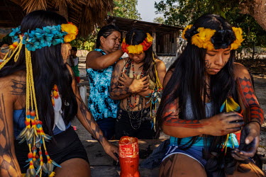 Manoki youths paint their bodies for a cultural event in an Irantxe Manoki indigenous village in Mato Grosso.