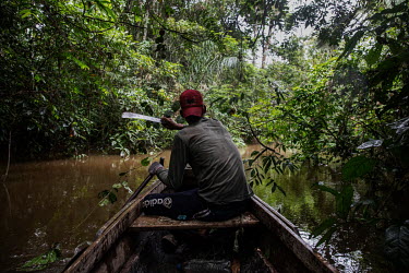 Jasson Oliveira do Nascimento, resident of the Arapixi Extractive Reserve, land designated for traditional sustainable and non commercial extraction of forest resources in Amazonas state, cuts the veg...