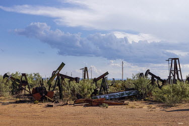 Pumps used for oil extraction abandoned in a junkyard in McCamey, which calls itself 'the wind capital of Texas', although the city is still economically dependent on oil extraction.