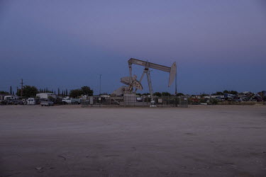 Oil extraction well next to a junkyard near the city of Odessa, Texas. This region of Texas, called the Permian Basin, is responsible for around a third of all oil production in the United States.