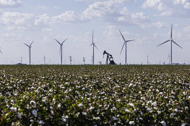 Oil extraction well amidst wind turbines near the city of Odessa, Texas. This region of Texas, called the Permian Basin, is responsible for around a third of all oil production in the United States.