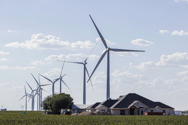 Oil extraction well amidst wind turbines near the city of Odessa, Texas. This region of Texas, called the Permian Basin, is responsible for around a third of all oil production in the United States.