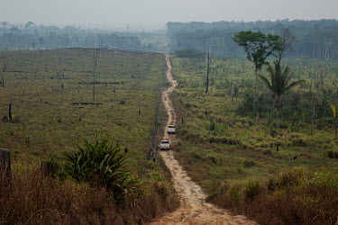 Surveillance vehicles from IPAAM (Amazon Environmental Protection Institute), escorted by military police, travel along a track road in search of a recent deforestation area in the municipality of Apu...