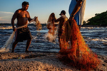 Local fishermen use nets to fish on the rapids of Rio Negro in Sao Gabriel da Cachoeira, Amazonas State.
