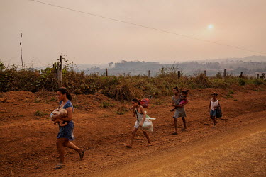A family who have recently arrived from Rondonia, a neighbouring state, walking along the Trans Amazonian highway in the rural area of Apui, in southern Amazonas.