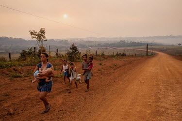 A family who have recently arrived from Rondonia, a neighbouring state, walking along the Trans Amazonian highway in the rural area of Apui, in southern Amazonas.