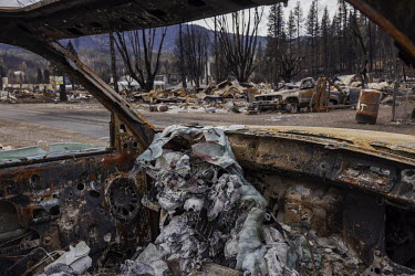 Melted glass inside a burning car in the historic Northern California town of Greenville, which was destroyed by a wildfire. The town was devastated by flames from the Dixie Fire, the largest forest f...