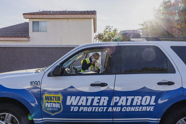 Perry Kaye, 61, a water waste investigator for the Las Vegas City Hall prepares informational material to leave at a residence in the city suburb that was not respecting the regulations for the correc...