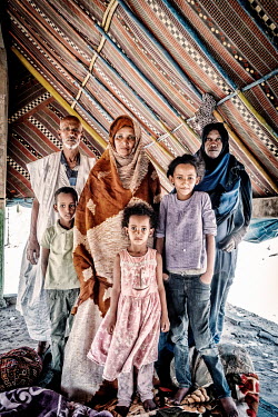 Portrait of Vaudna Mint Mohammed with her family. Vaudna was a team leader for the irrigation building works in village.