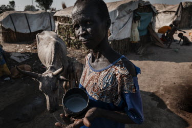 This is all the milk Angelina can get out of her cow. The cow appears to be on its last legs. 'My son Ruai is very sick, and I have almost no milk for him.' Hundreds of thousands of people have been d...