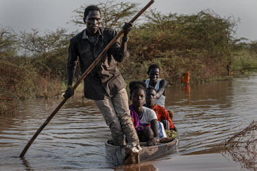 A man steers a boat through the flood waters. Hundreds of thousands of people have been displaced by flooding which is occurring for the third year in a row, depriving people of livelihoods, flooding...