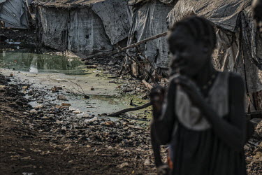 Children walk along a path covered in rubbish and dirty water in the Protection of Civilians (POC) camp for internally displaced peopel (DPs). This is the largest camp in South Sudan normally shelteri...