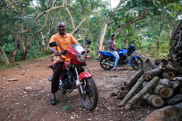 Maturaffi Abdallah (left), president of the island branch of the Comorian Inter Professional Association of the Ylang Flower and Hadji Radjabou, Treasurer, astride their motorcycles at Abdallah's ylan...