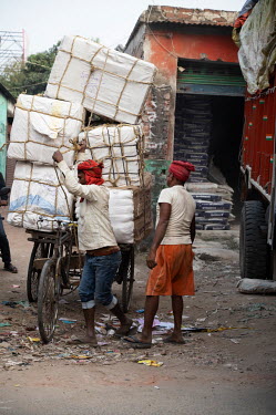 Men loading a tricycle-cart.