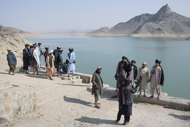 Taliban relax on the banks of the Arghana Dam reservoir, near Kandahar, where water level has dropped significantly over the past two years.