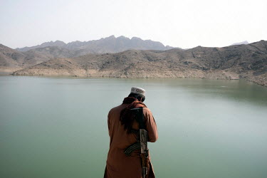 Taliban relax on the banks of the Arghana Dam reservoir, near Kandahar, where water level has dropped significantly over the past two years.