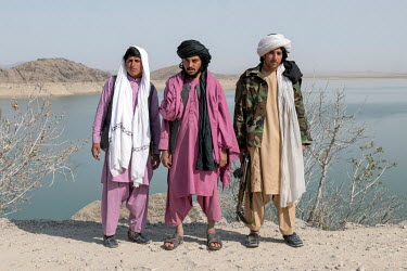 Taliban pose on the banks of the Arghana Dam reservoir, near Kandahar, where water level has dropped significantly over the past two years.