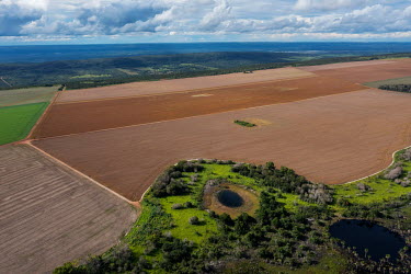 Aerial view of one of the springs that is part of the Environmental Protection Area for the headwaters of the Paraguay River, where the river begins, surrounded by land prepared for intensive agricult...