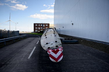 A 100 metre long wind turbine blade is stationed outside a vast wind turbine blade testing building, at the Catapult Innovation and Research Centre for Offshore Renewable Energy. The former coal minin...